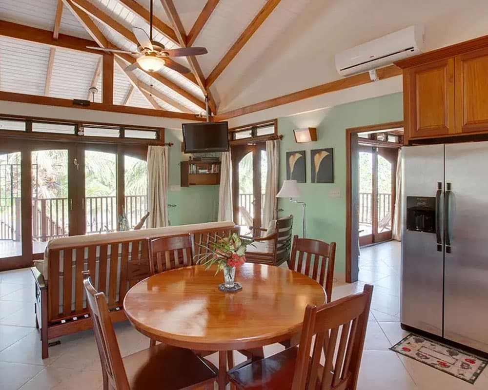 Bright, airy kitchen and dining area with wooden accents and large windows.